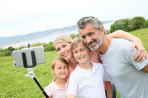Family in vacation taking selfie picture with smartphone