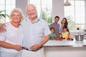 Grandparents in front of their family in the kitchen